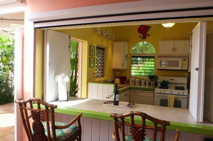 The air conditioned main kitchen with its breakfast bar and motorized screen