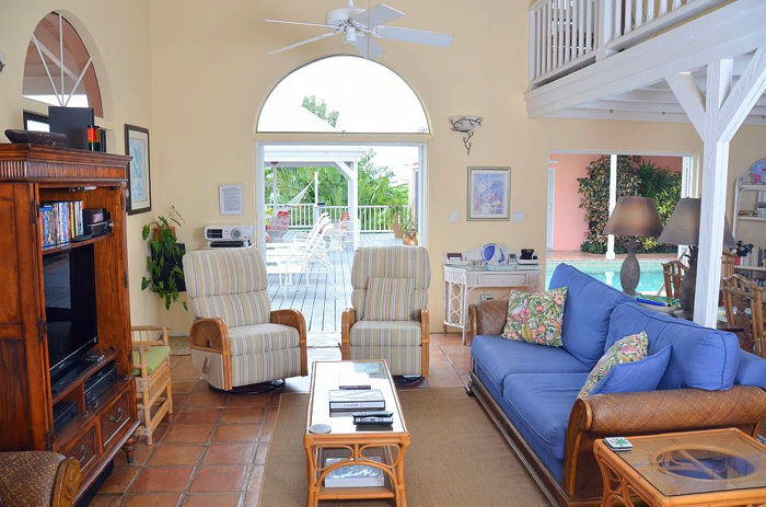 The great room includes a 100 inch projection system and dual rattan recliners